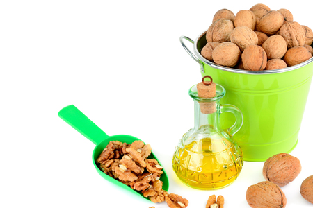 Oil of walnut and nut fruit isolated on white background. Free space for text.の写真素材