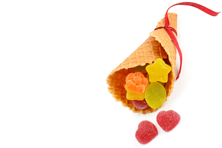 Marmalade candies in a waffle horn isolated on white background. Free space for text.の写真素材