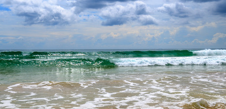 Dramatic cloudscape with heavy rain and tropical storm at the horizon on the coastline of Sri Lanka. Wide photo.の写真素材