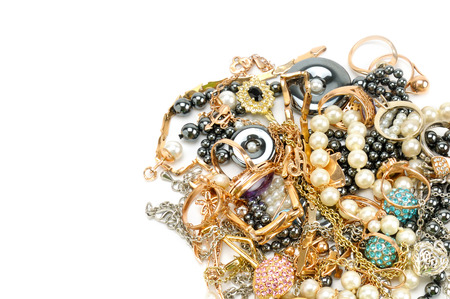 Gold jewelry isolated on white background. Flat lay, top view. Free space for text.の写真素材