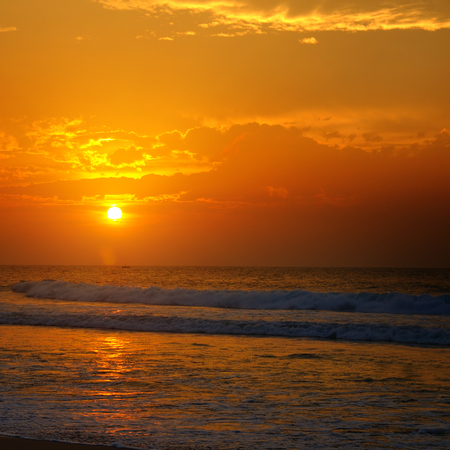 Beach of the ocean and golden sun rise. Bright beautiful background.の写真素材