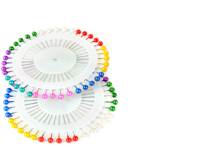 Bright colored pins isolated on white background. A set of sewing accessories. Free space for text.の写真素材
