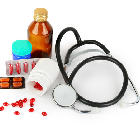 Stethoscope, pills and medical preparations isolated on white background.の写真素材