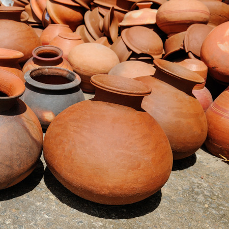 Rustic handmade ceramic clay brown terracotta pots souvenirs at street handicraft marketの写真素材