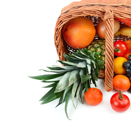 Vegetables and fruits in a basket isolated on white background. Healthy food. Free space for text.の写真素材