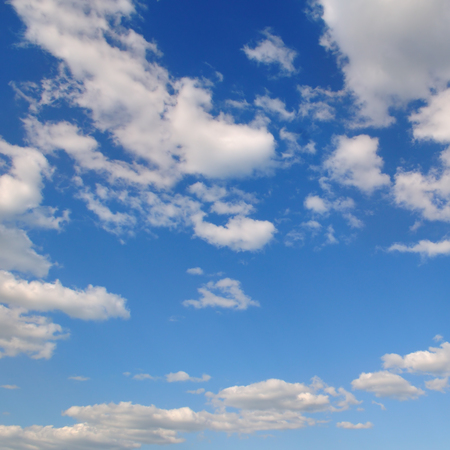 Light cumulus clouds in the blue sky. A bright sunny day.の写真素材