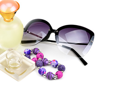 bottles, sunglasses and bracelet isolated on white background. Fashionable women's accessories. Free space for text.の写真素材