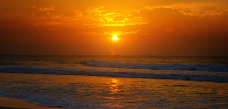Beach of the ocean and golden sun rise. Bright beautiful background. Wide photo.の写真素材
