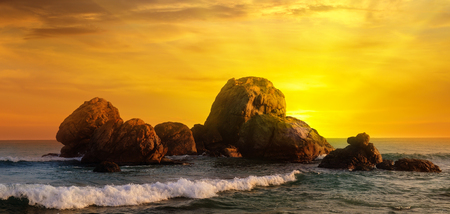 Sea landscape with rocky island and the sunrise.の写真素材