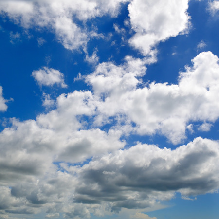 White cumulus clouds against the blue sky.の写真素材