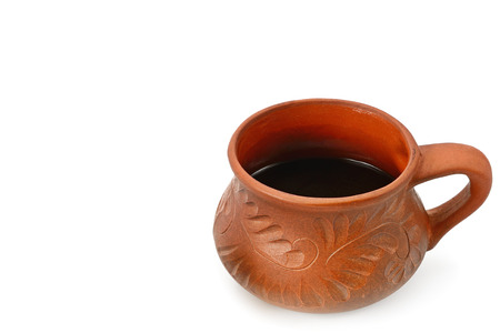 Hot coffee in a clay cup isolated on white background. Free space for text.の写真素材