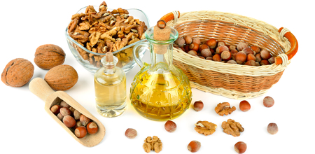 Oil of walnut and hazelnut, nut fruit isolated on white background. Wide photo.の写真素材