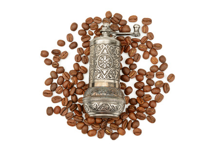 Manual coffee grinder and roasted coffee beans isolated on white background. Top viewの写真素材