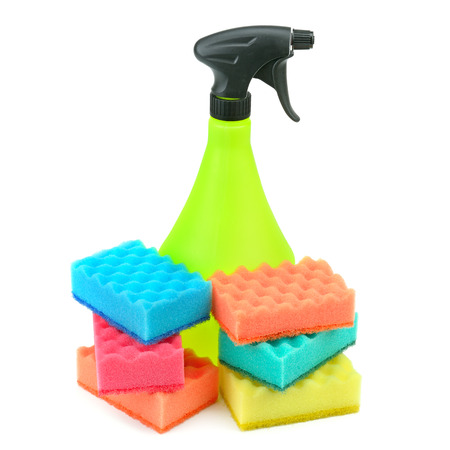 A spray of cleaning agents and household foam rubber sponges isolated on white background.の写真素材