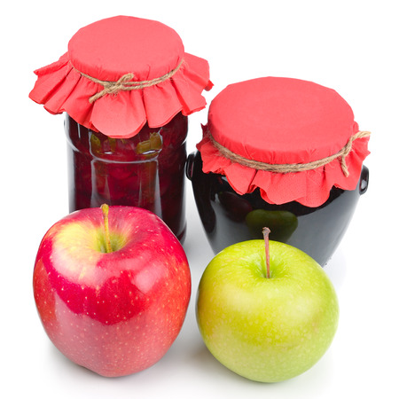 Apple jam in a glass jar, fresh red and green apples isolated on white background. Healthy foodの写真素材