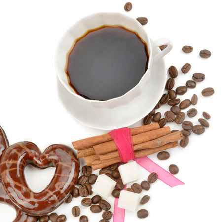 Cup with coffee, beans coffee and biscuits in the form of hearts isolated on white background.の写真素材