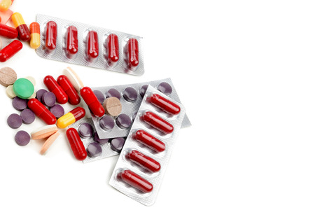 Assorted pharmaceutical medicine pills, tablets and capsules isolated on white background. Flat lay, top view. Free space for text.の写真素材