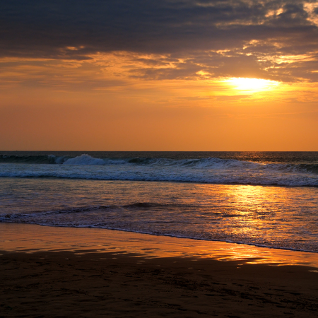 Beach of the ocean and golden sun rise. Bright beautiful background.の写真素材
