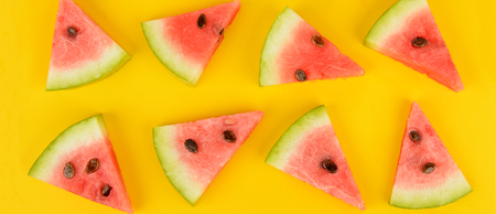 Sliced ripe juicy watermelon on a bright yellowの写真素材