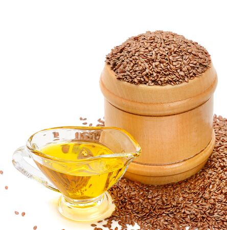 Flax seeds and oil isolated on whiteの写真素材