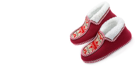 A pair of cozy home slippers isolated on a white background. Free space for your text. Wide photo.