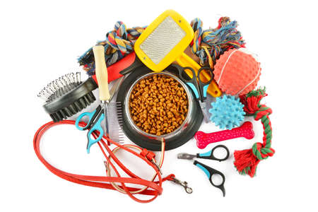 Pet accessories concept. Dry food, collars and rubber toys for pet on isolated white background.の写真素材