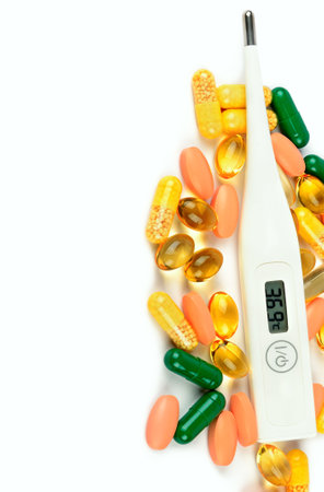 Medical thermometer and pills isolated on white background. Prevention and diagnosis of coronavirus infection. Free space for text.の写真素材