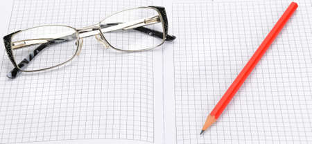 Eye glasses, blank notepad and pen on a white background. Wide photo.の写真素材