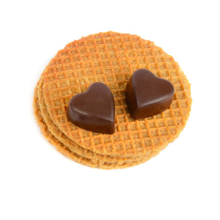Chocolate in the form of hearts on Belgian waffles solated on a white background.の写真素材