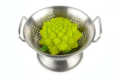 Romanesco broccoli in steel colander isolated on white background.の写真素材
