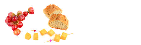 A bunch of grapes , baguette and cheese isolated on a white background. Free space for text. Wide photo.の写真素材