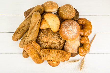 Bread, baguettes and sweet pastries on a white background.