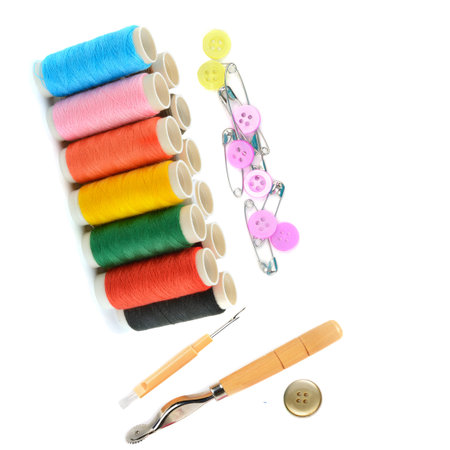 A set of threads, buttons and other sewing accessories isolated on a white background. Collage. Free...