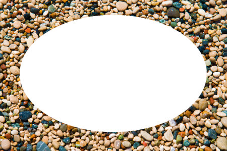 Multicolored wet pebbles on the Mediterranean beach. Original oval frame made of sea pebbles with space for text.の写真素材