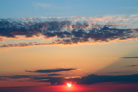 Beautiful sky with bright sunset (sunrise) and light clouds.の写真素材