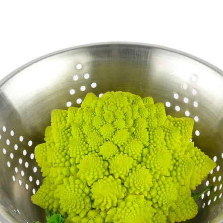 Romanesco broccoli in colander isolated on white background.の写真素材