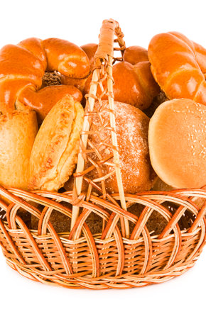 Bread and sweet pastry in a wicker basket isolated on white background. Vertical photo.の写真素材