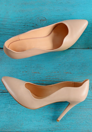 Elegant women's shoes with high heels on a blue background. View from above. Vertical photo.の写真素材