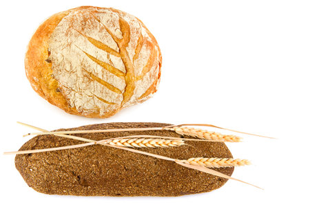 Bread, baguette and ears of wheat isolated on white background. Free space for text.の写真素材
