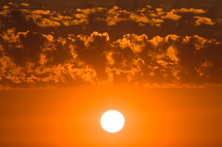 Cloudy sky and bright sunrise over the horizon.の写真素材