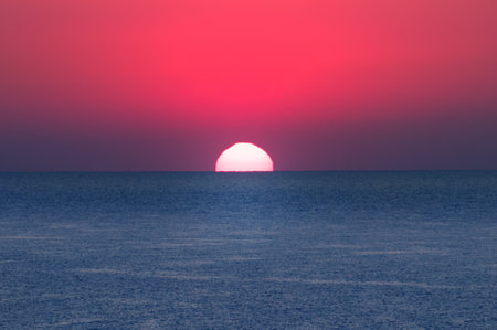 Beach of the sea and red sun rise. Bright beautiful background.の写真素材