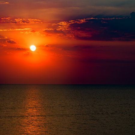 Beach of the sea and red sun rise. Bright beautiful background.の写真素材