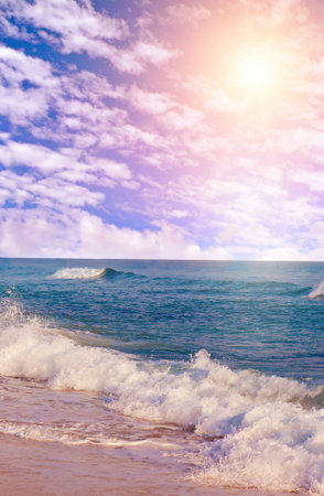 Sea tropical beach and sun on blue cloudy sky. Vertical photo.の写真素材