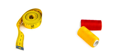 Sewing threads and measuring tape isolated on a white background. There is free space for text....