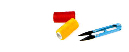 Scissors and a skeins of thread for sewing isolated on a white background. There is free space for...