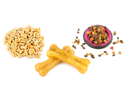 Dry food, dog biscuits and chewing bones isolated on white background. Collage. Free space for text.の写真素材