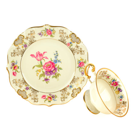 Vintage porcelain plate with traditional bouquet and Vintage porcelain cup isolated on white background.の写真素材