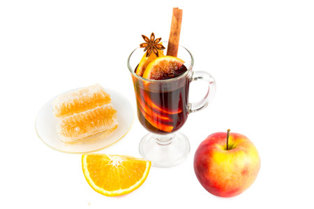 Hot red mulled wine with christmas spices, orange slice, anise and cinnamon sticks isolated on a white background.の写真素材
