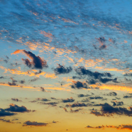 Real majestic sunrise sundown sky background with gentle colorful clouds without birds.の写真素材