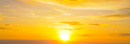 Cloudy sky and bright sunrise over the horizon. Wide photo.